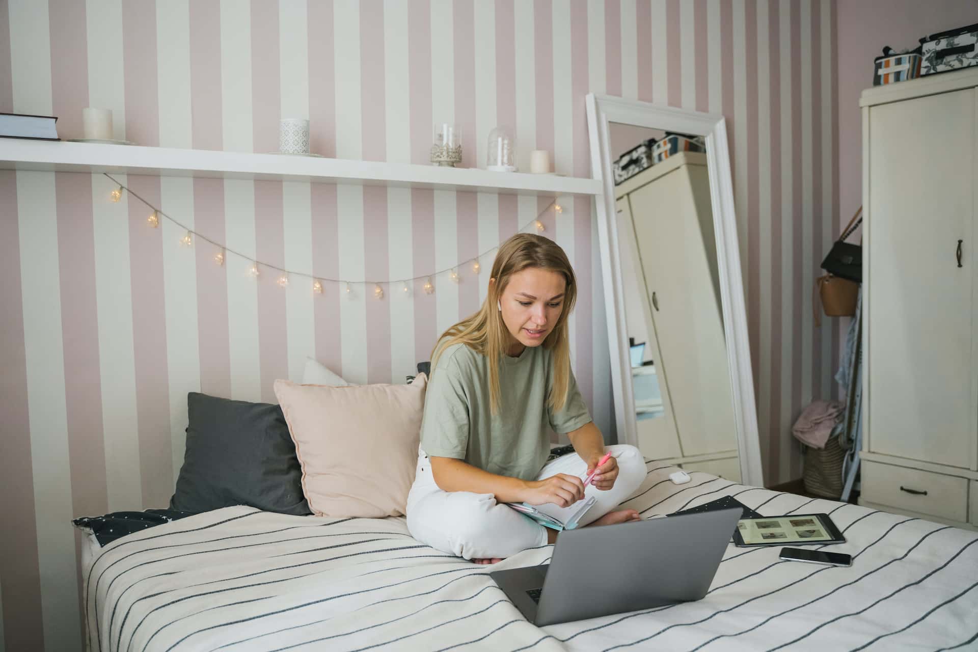 Blonde woman on bed with laptop